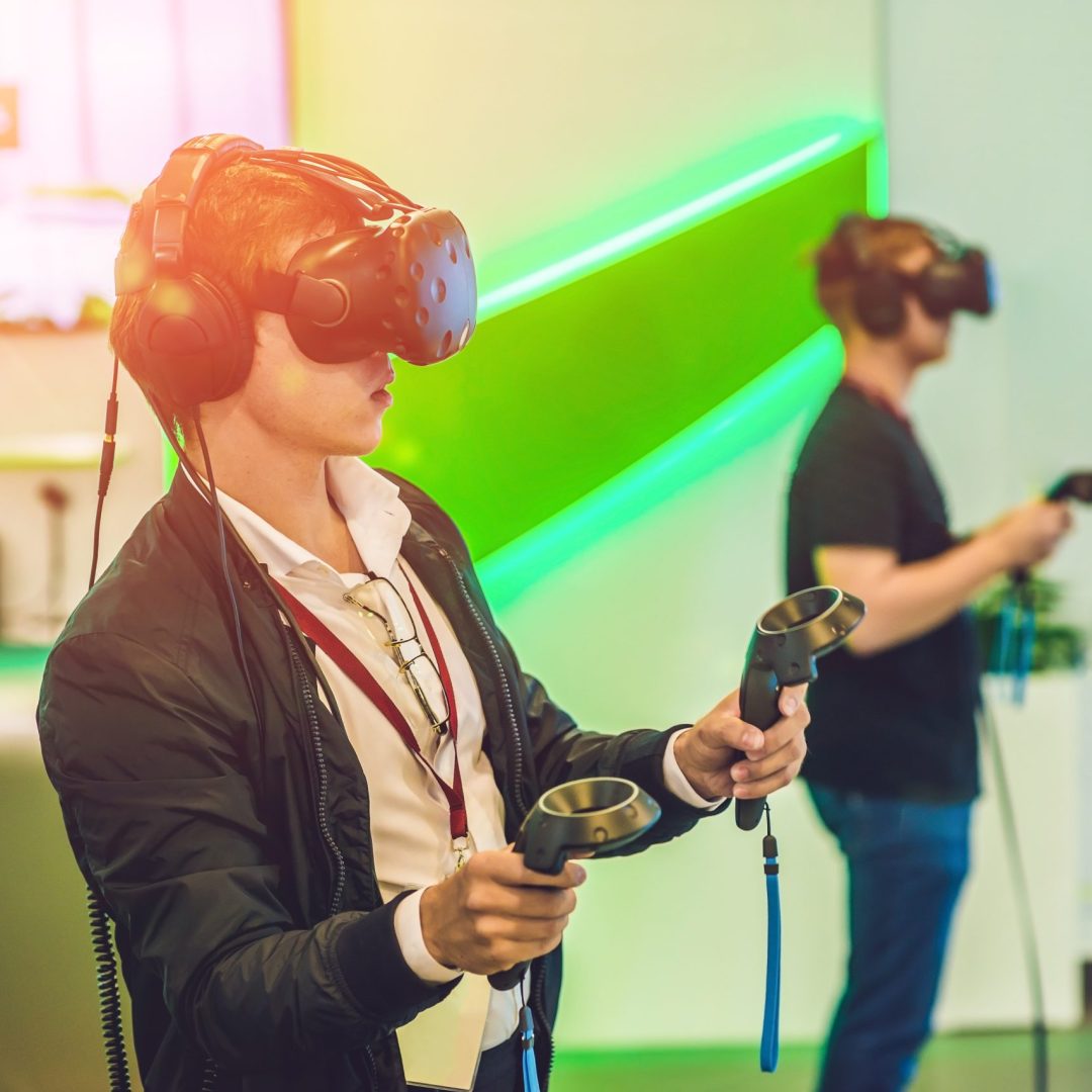 Young man playing video games virtual reality glasses. Cheerful man having fun with new trends technology - Gaming concept.